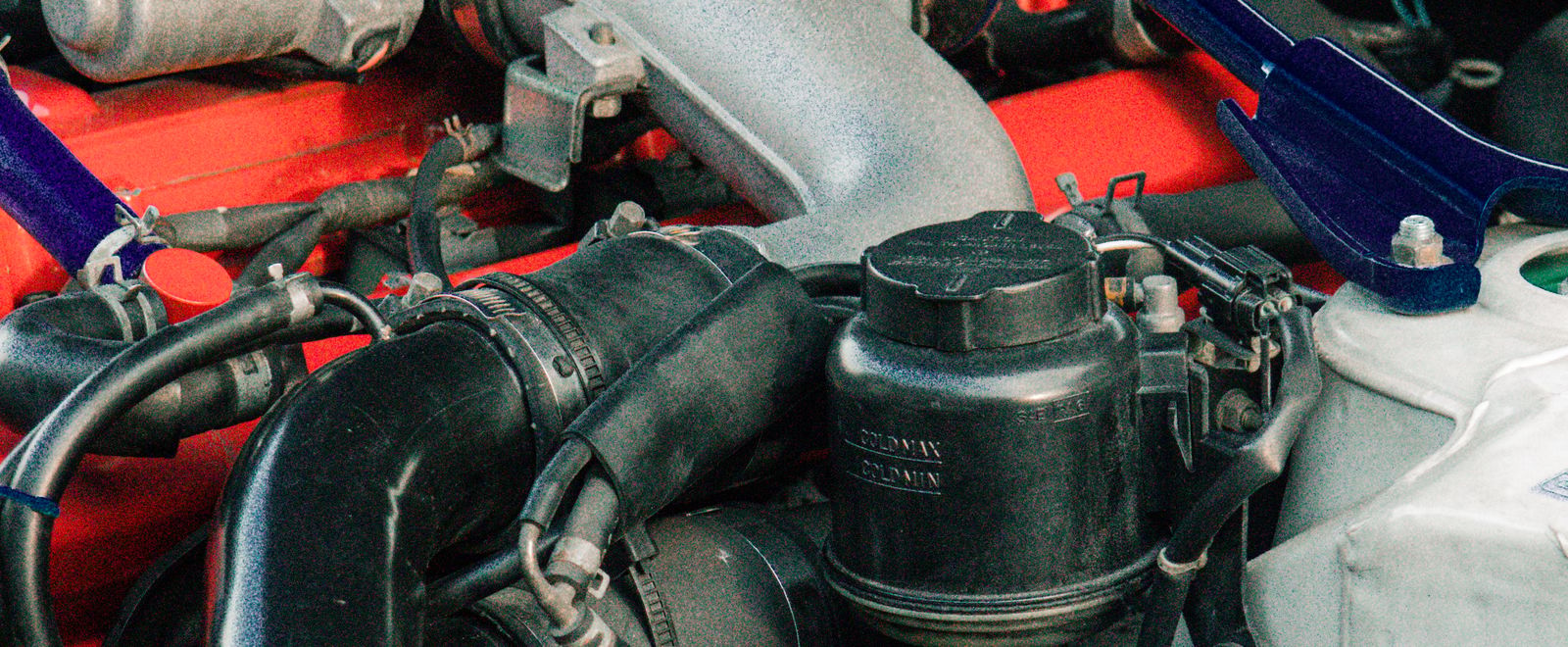 Close-up of a vehicle engine bay during inspection and repair
