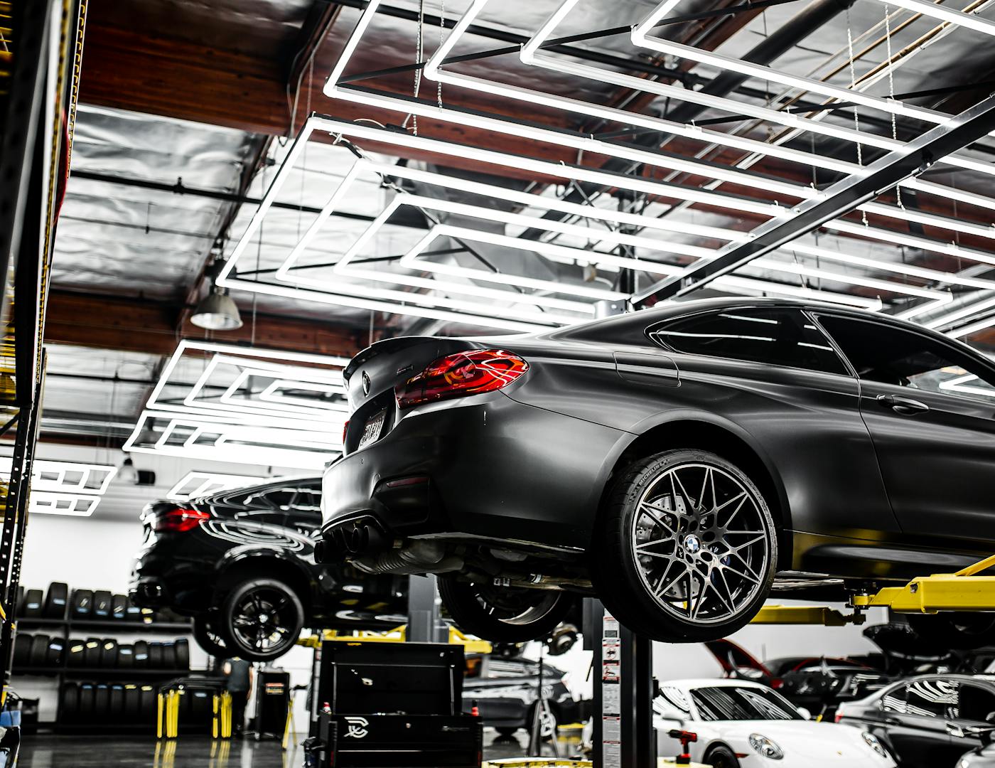 Bright, modern auto repair shop interior with vehicles on hydraulic lifts